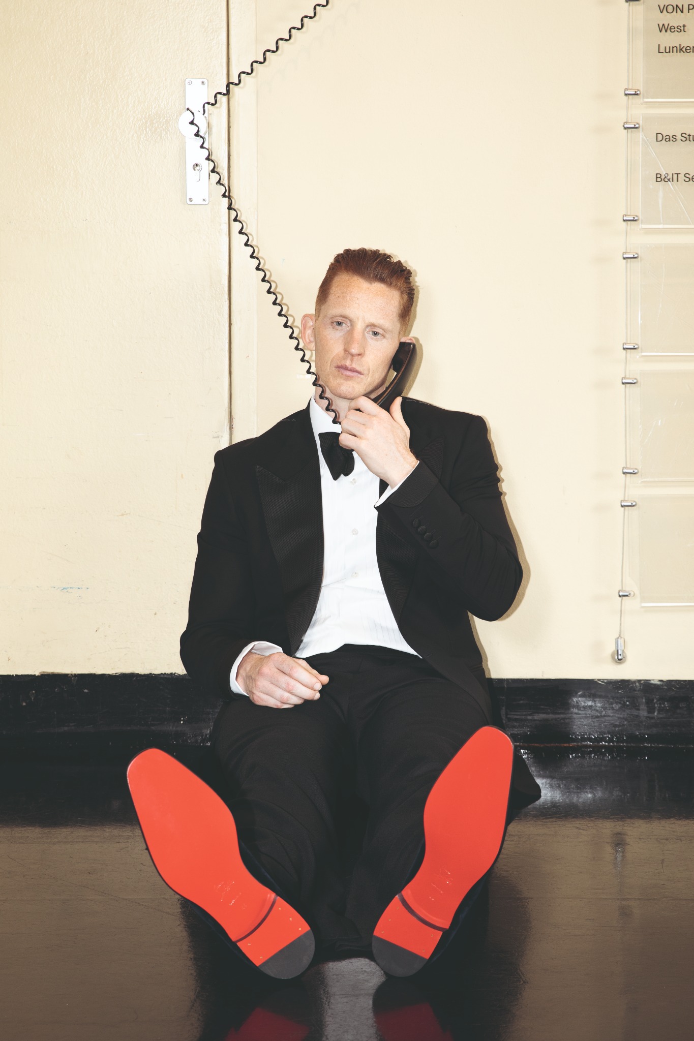Andreas G. Hansen in a tuxedo holding a telephone, APROPOS Journal Autumn/Winter 2026 — photo by Jonathan LLensee