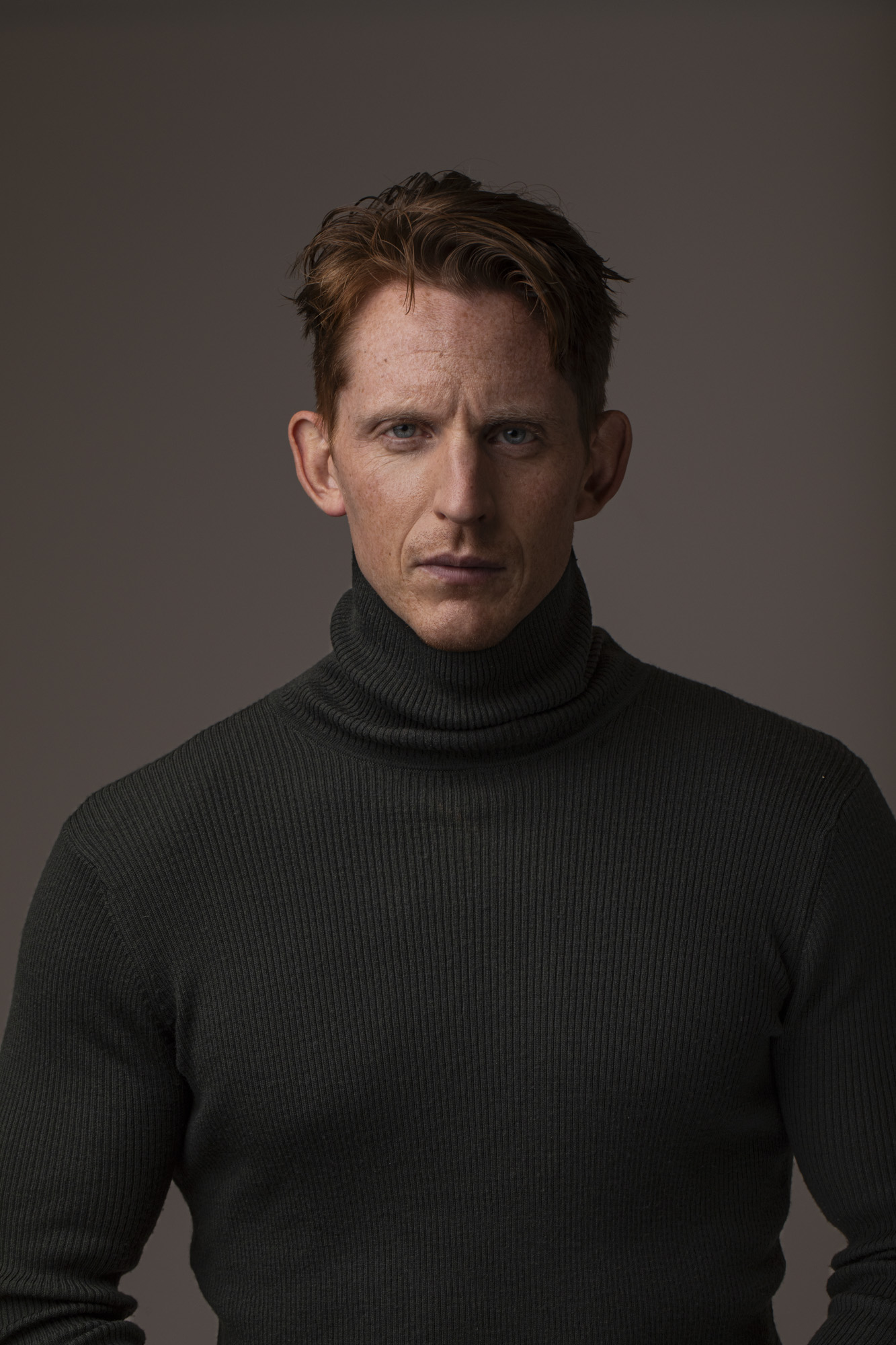 Andreas G. Hansen dramatic actor headshot in a black turtleneck